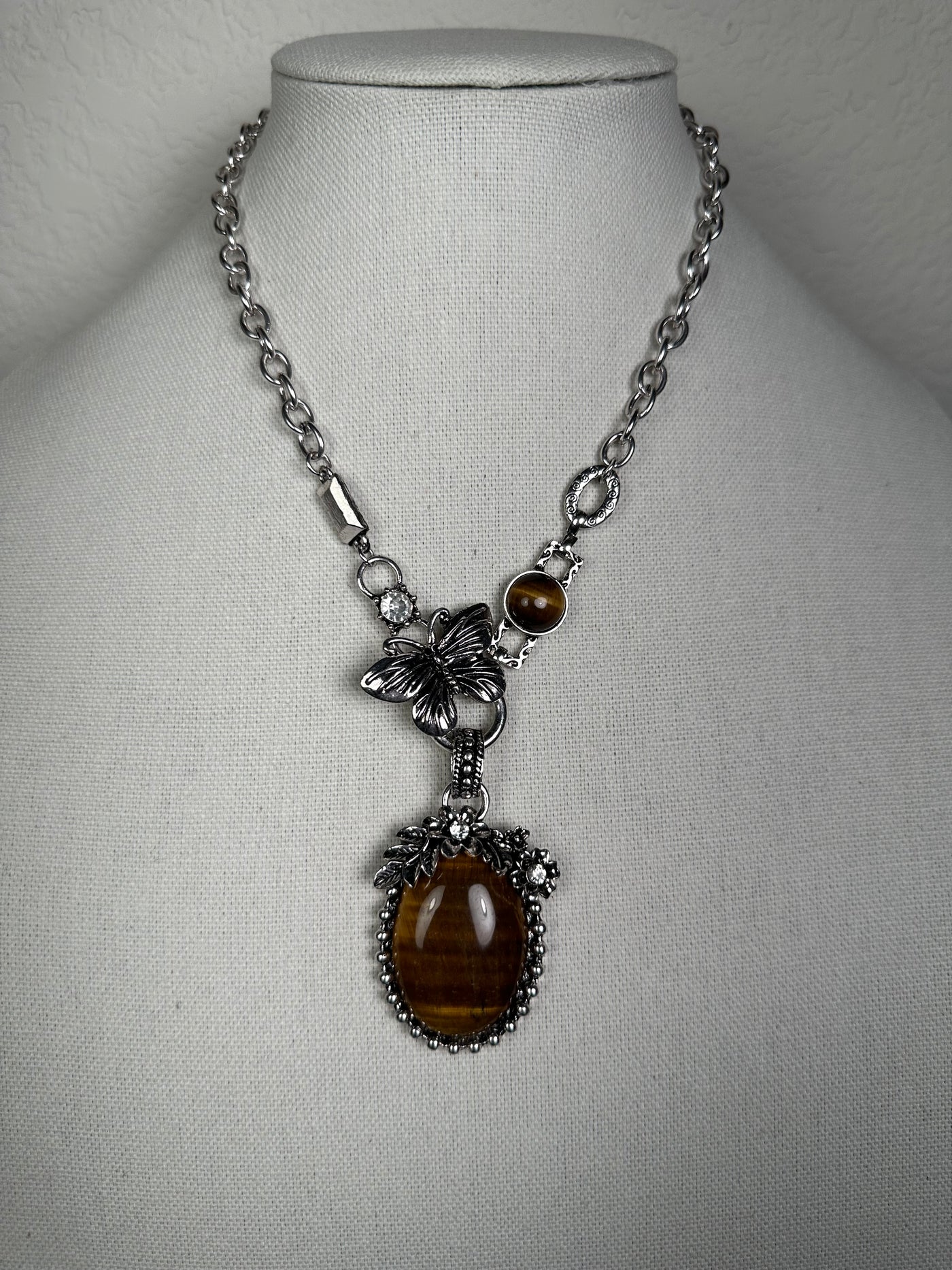 Silver Tone Necklace with an Ornate Oval Howlite Tiger Eye Drop