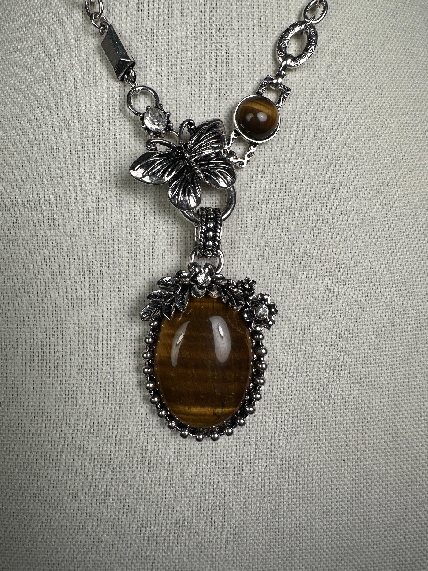 Silver Tone Necklace with an Ornate Oval Howlite Tiger Eye Drop