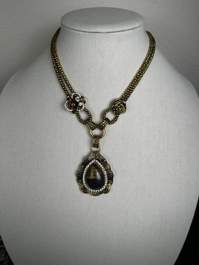 Yellow Gold Tone Necklace Featuring an Ornate Howlite Tiger Eye Pendant