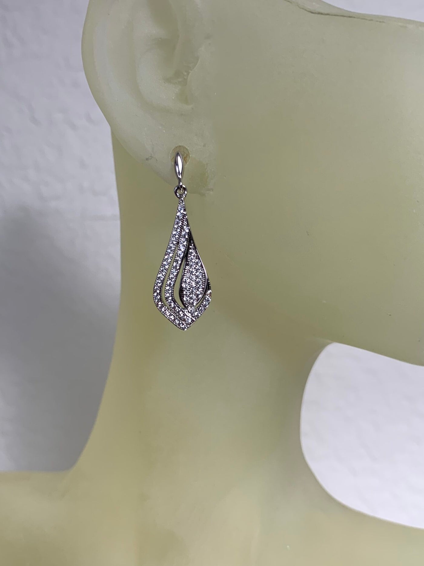 Silver Tone Dangling Earrings Decorated with Pave Set Cubic Zirconia