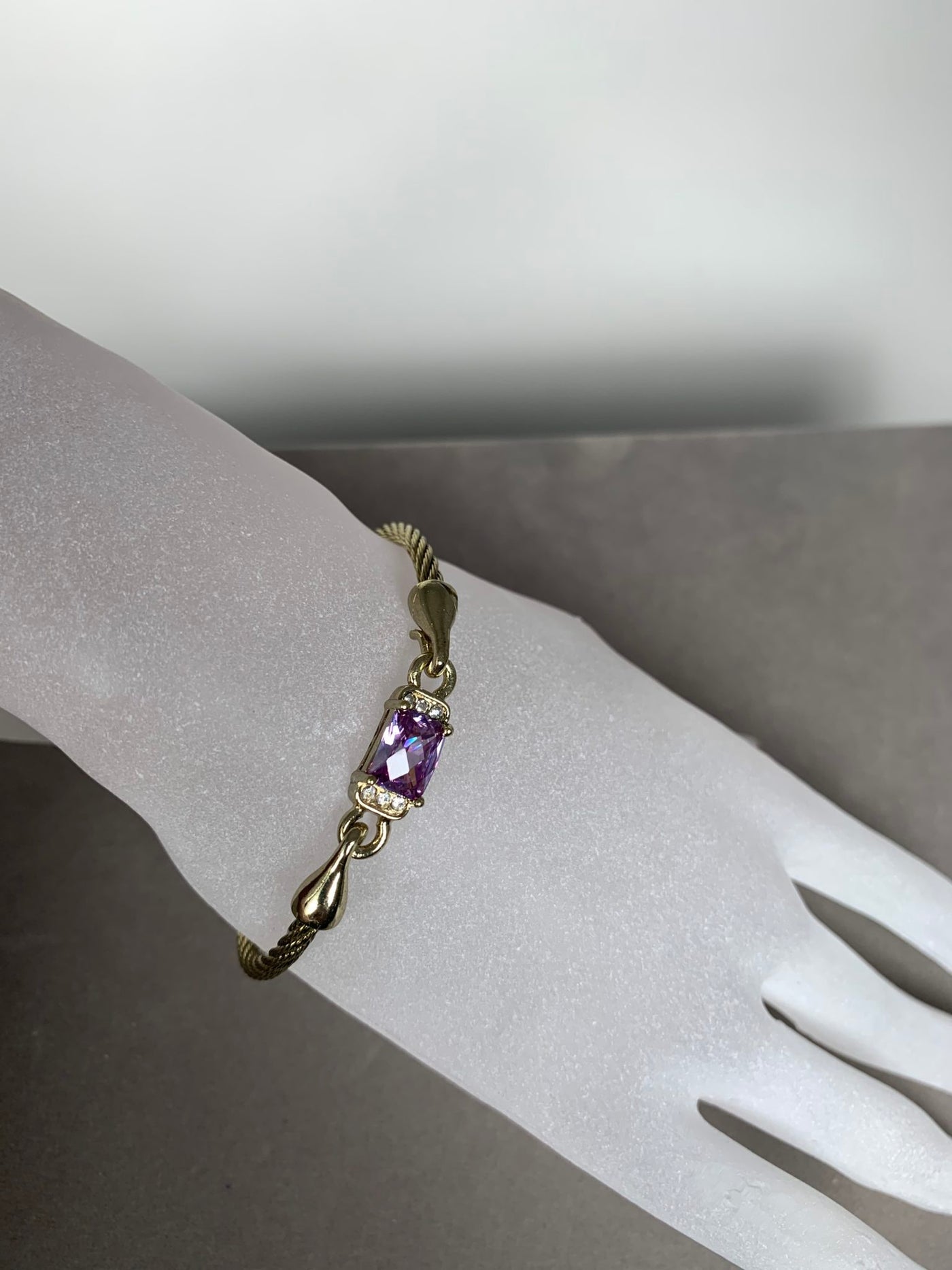 Yellow Gold Tone Wire Bangle Bracelet featuring Purple Crystal