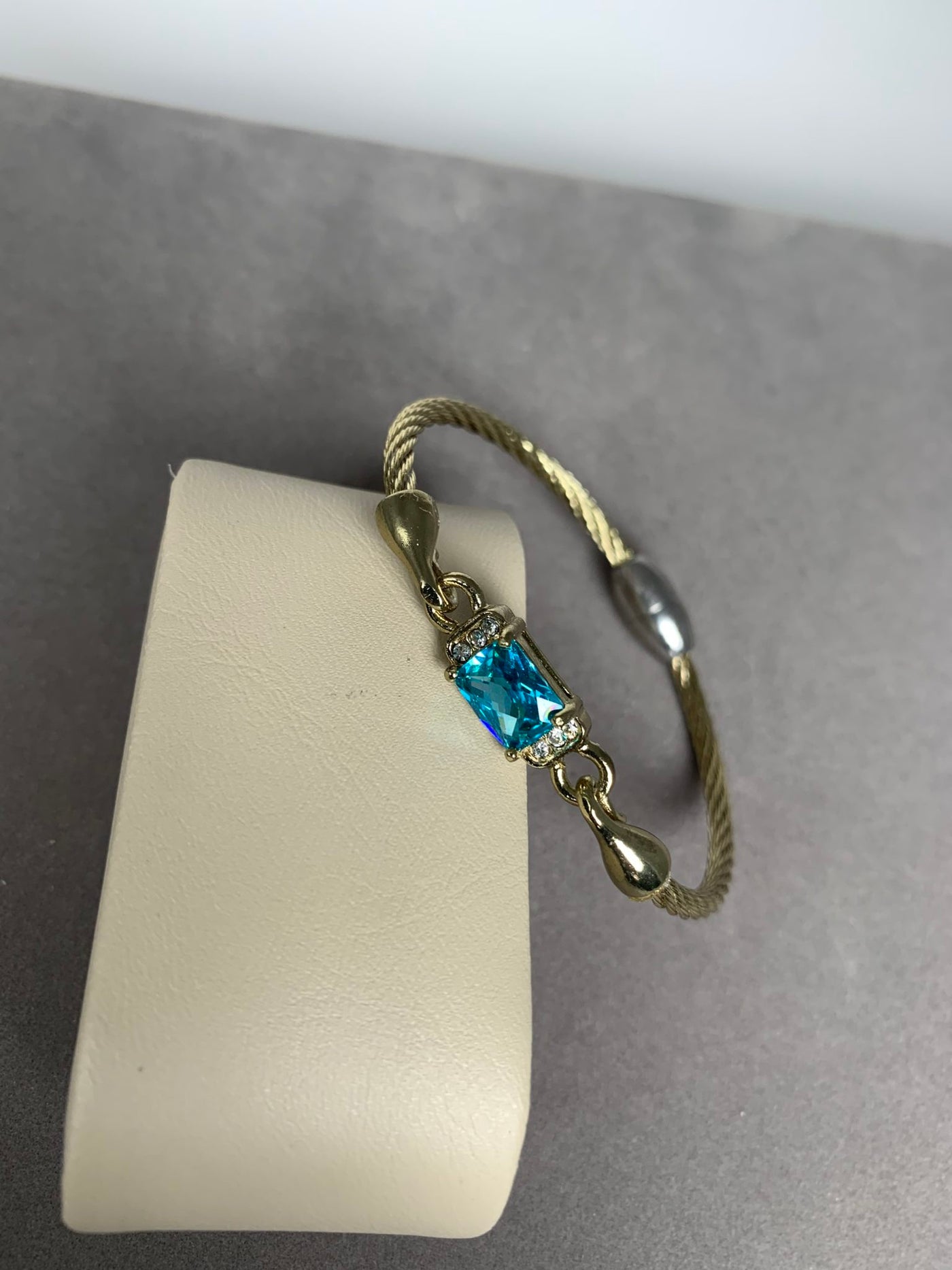 Yellow Gold Tone Wire Bangle Bracelet featuring Sea Blue Color Crystal