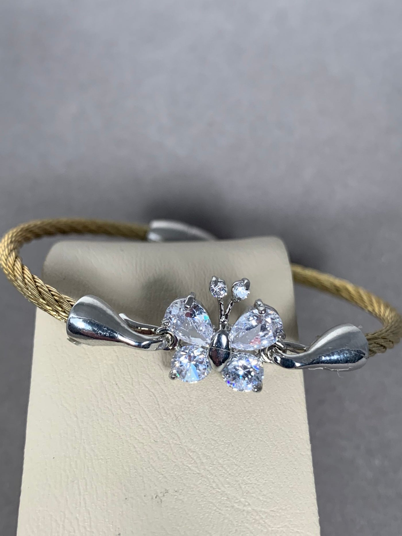 Gold Tone Wire Bangle Bracelet featuring Clear Crystal Butterfly