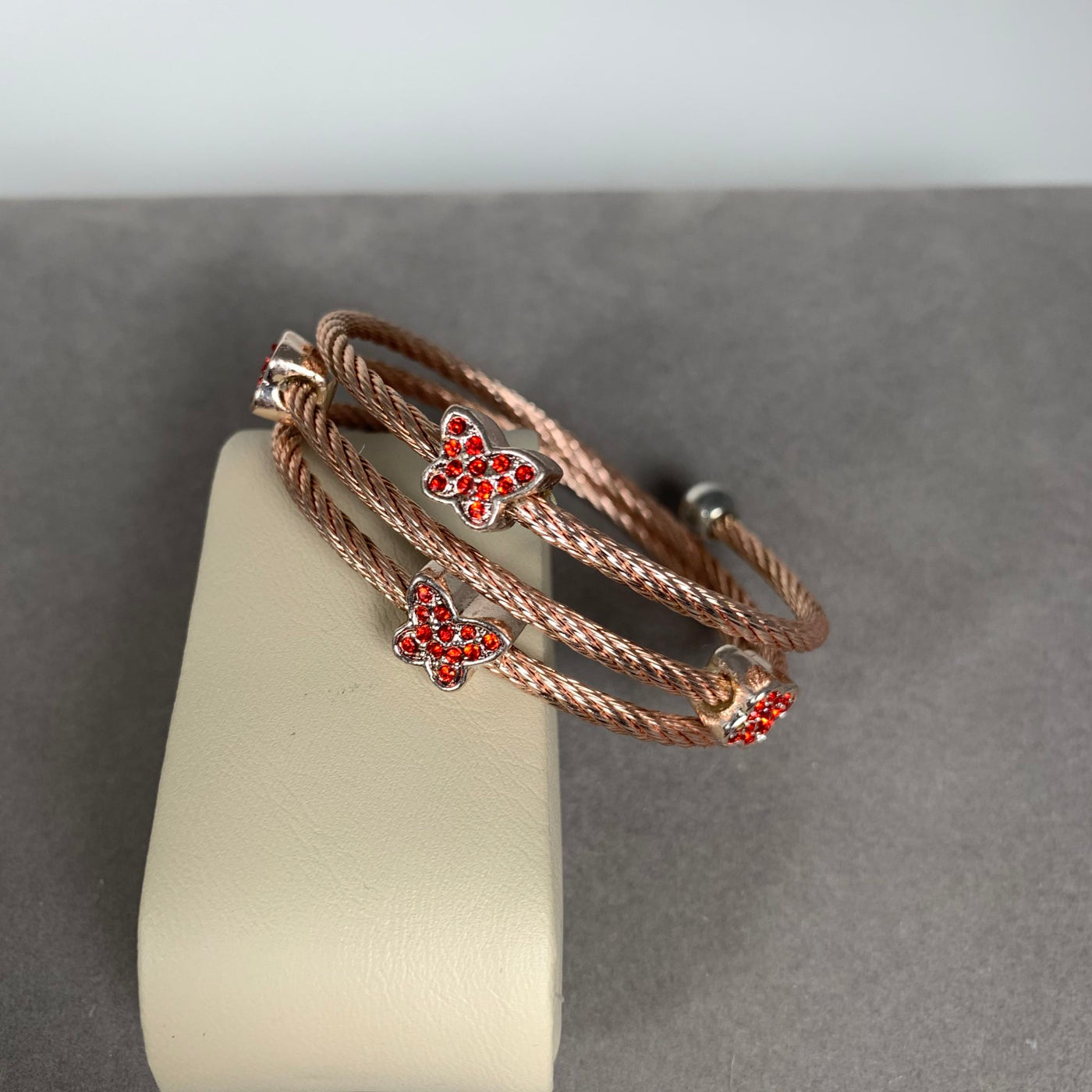 Rose Gold Tone Spiral Wire Bangle Bracelet with Red Crystal Motifs