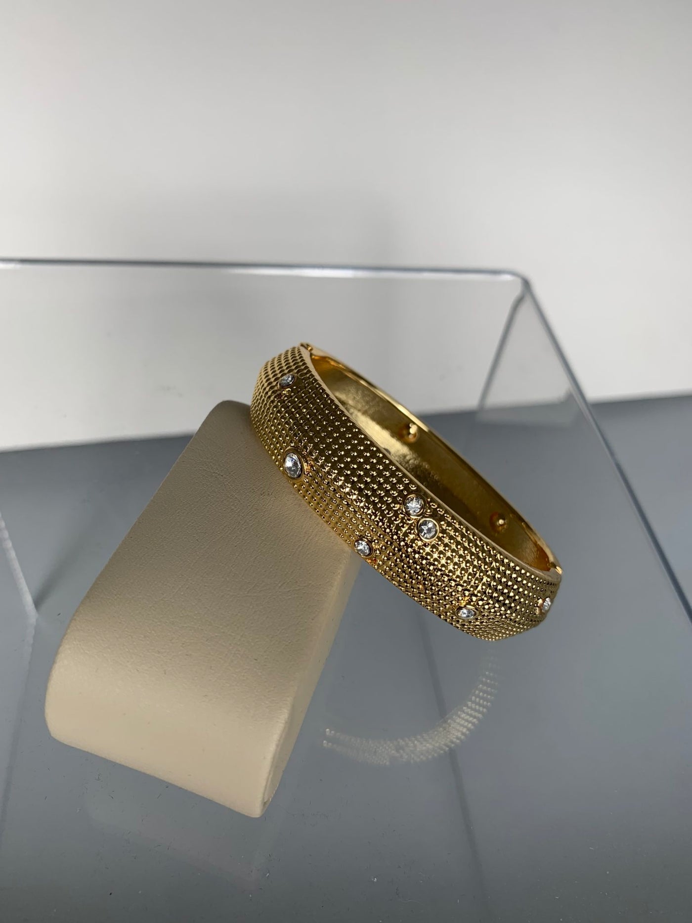 Oval Bangle Decorated with Scattered Crystals in Gold Tone