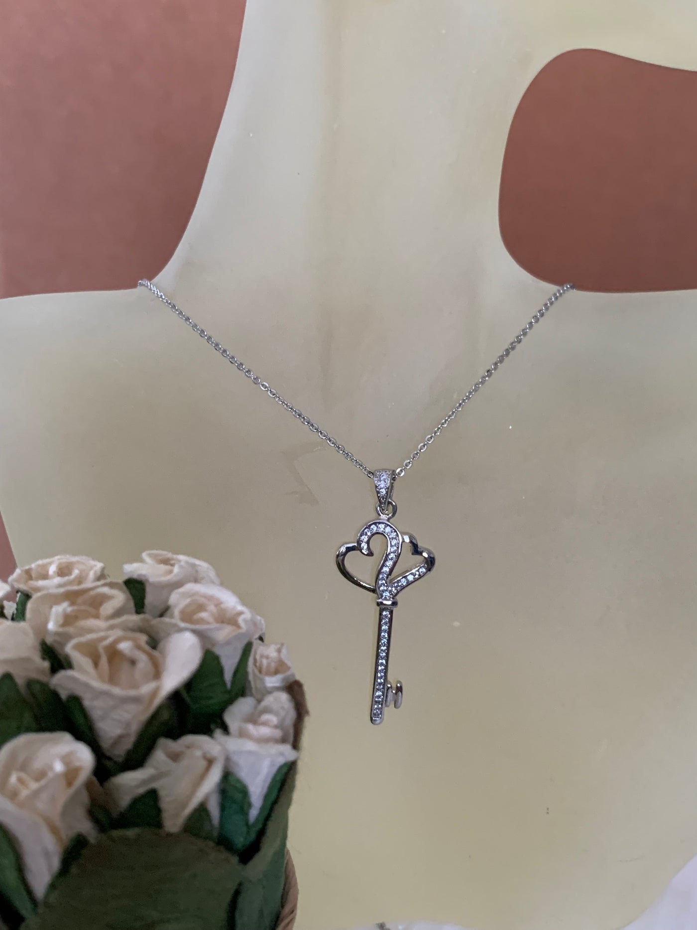 Pave Set Cubic Zirconia Double Heart Key Pendant Necklace in Silver Tone