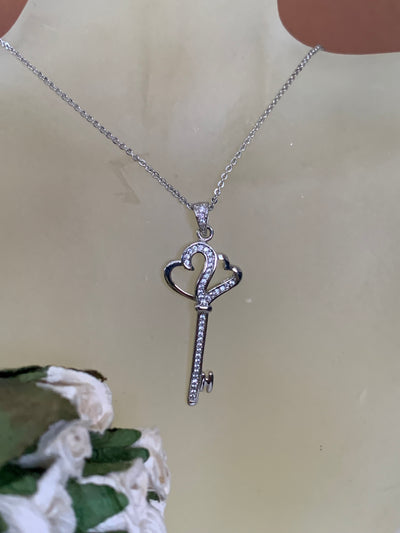 Pave Set Cubic Zirconia Double Heart Key Pendant Necklace in Silver Tone